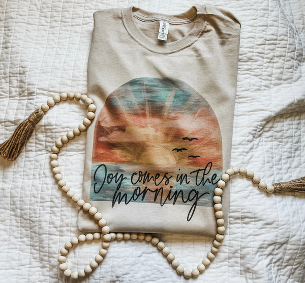 Joy comes in the morning tan tee